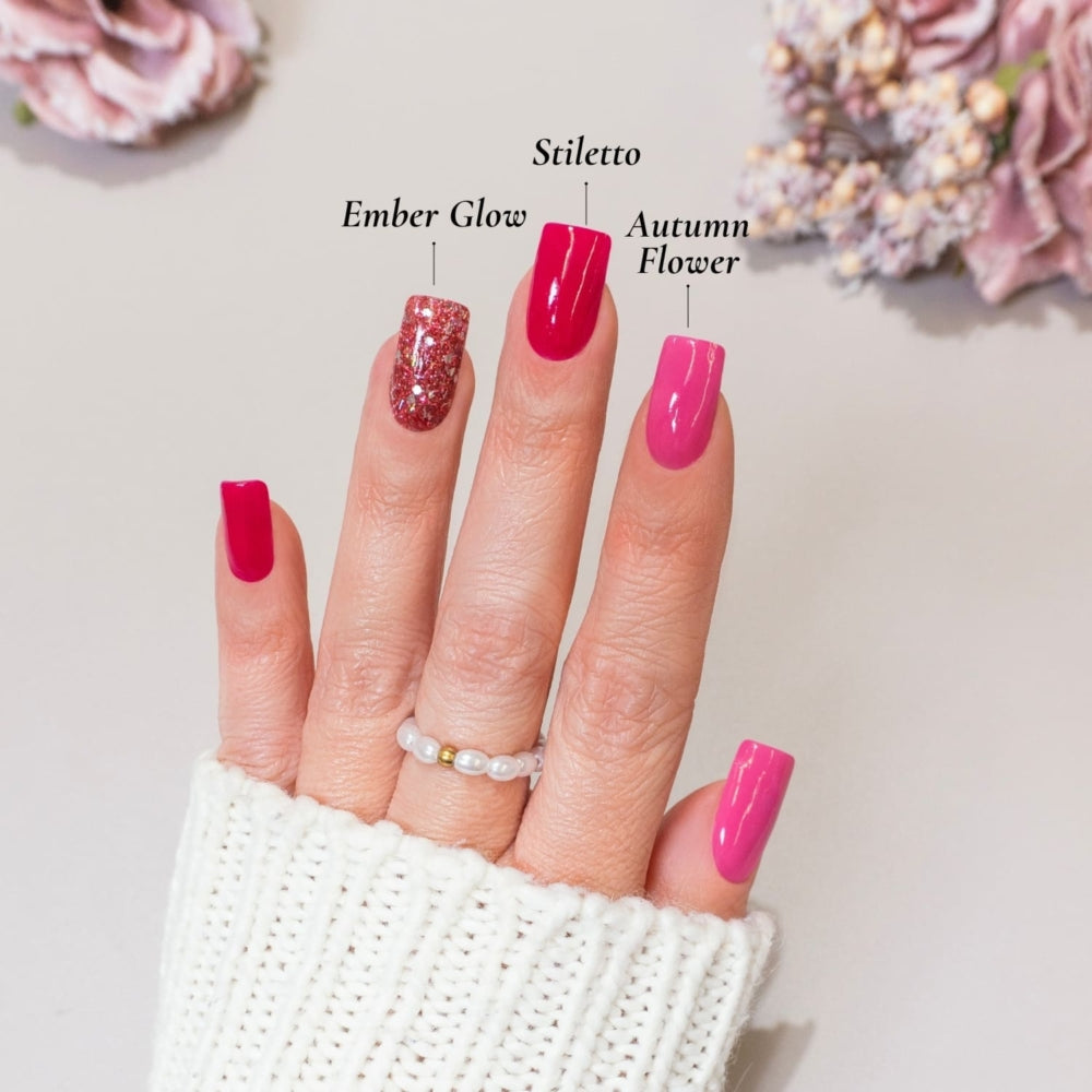 DIY-Maniküre mit DIPDRIP Ember Glow (leuchtendes Pink), Stiletto (tiefes Rot), und Autumn Flower (zartes Rosa) für ein elegantes Nageldesign.
